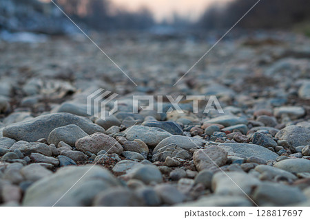 Close-up of natural landscape, multi-faceted view of dry river with waterless bottom. Changes in state of natural objects as result of influence of large corporations in order to obtain huge profits 128817697