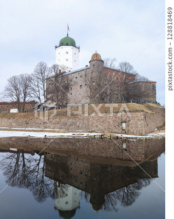 View of a medieval Swedish castle on an island, Vyborg. A photograph of a fortress and a castle reflected in the water, on a spring day. 2024. View of a medieval Swedish castle on an island, Vyborg. A photograph of a fortress and a castle reflected in the water, on a spring day. 2024. 128818469