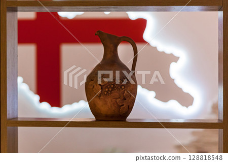 Clay wine jug with grape ornament in Georgian restaurant Clay wine jug with grape ornament in Georgian restaurant 128818548