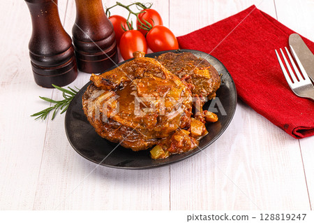 Italian cuisine - ossobuco with sauce Italian cuisine - ossobuco with sauce 128819247
