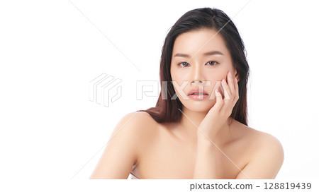 A beautiful young Asian woman with clean, fresh skin against a white background. Skincare, facial treatment, cosmetology, beauty, and spa. An elegant portrait of an Asian woman. 128819439
