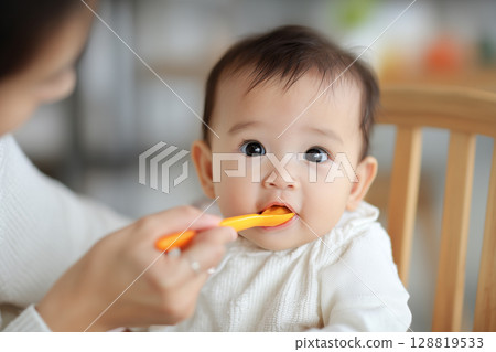 "Generative AI" shows adorable baby being fed by mom 128819533