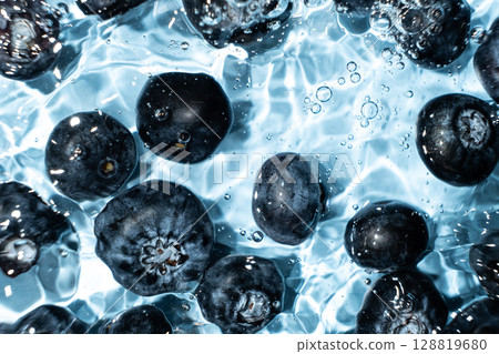 Berry background of fresh whole blueberries in water, splash of water, top view 128819680