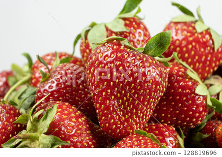 Ripe strawberries background. Sweet seasonal fruit concept. Ripe strawberries background. Sweet seasonal fruit concept. 128819696