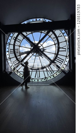 Silhouette of Person Admiring View Through Giant Clock Silhouette of Person Admiring View Through Giant Clock 128819783
