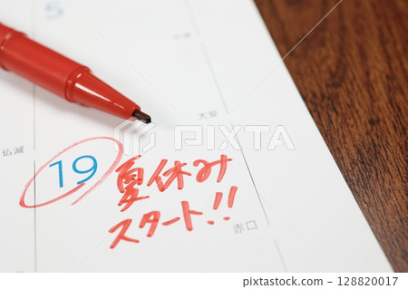 Summer vacation start date written on a calendar with red handwritten text 128820017