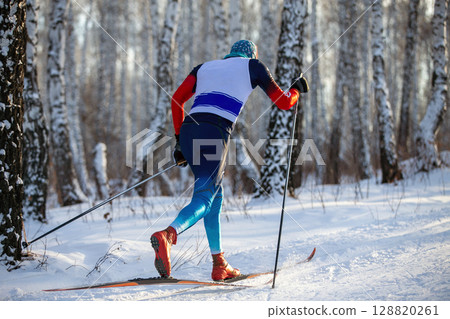 rear view skier in birch forest at ski racing competition 128820261