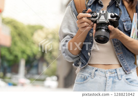 Photography Passion. Young woman holding camera ready to capture moments. Photography Passion. Young woman holding camera ready to capture moments. 128821042