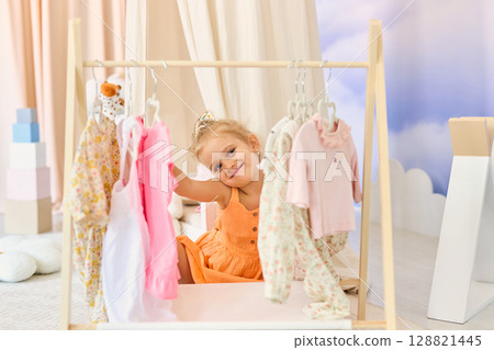A little girl chooses what clothes to wear 128821445