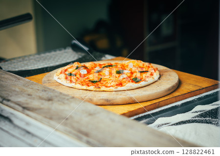 Chef Preparing Homemade Pizza with Ham and Basil Chef Preparing Homemade Pizza with Ham and Basil 128822461