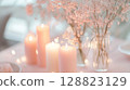 Blush pink party decorations with candles and soft fairy lights . 128823129