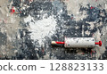 Painter roller with splashes of white on drop cloth . 128823133