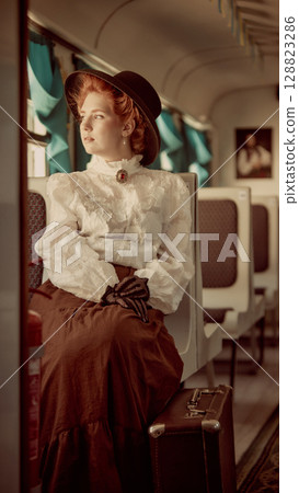 Woman in vintage outfit sitting on train with suitcase looking through window Woman in vintage outfit sitting on train with suitcase looking through window 128823286