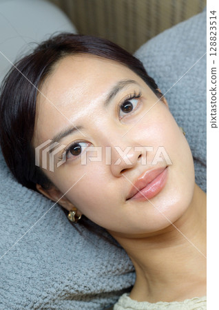 Serene young southeast asian woman shows natural beauty after an eyelashes extension procedure at salon focusing on female eyes health wellness and makeup 128823514