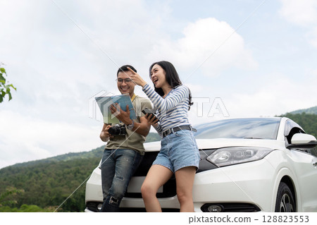 Couple sharing joyful moment while planning trip Couple sharing joyful moment while planning trip 128823553