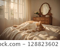 A fluffy ginger and white feline enjoys a peaceful slumber on a comfortable bed. Warm light, soft shadows, and hints of bedroom furniture create a cozy and relaxing atmosphere. 128823602