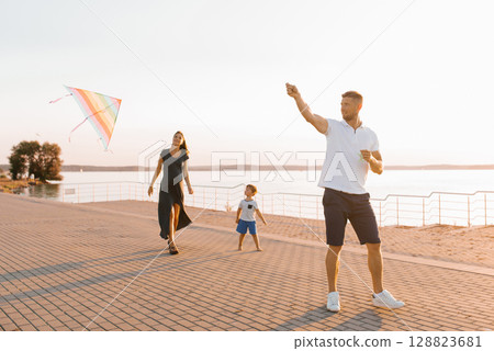 Family Enjoying Kite Flying Outdoors 128823681