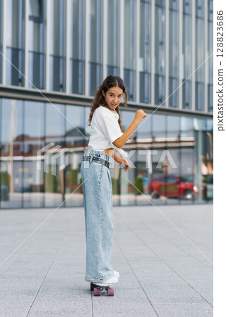 Girl Riding Skateboard Outdoors Girl Riding Skateboard Outdoors 128823686