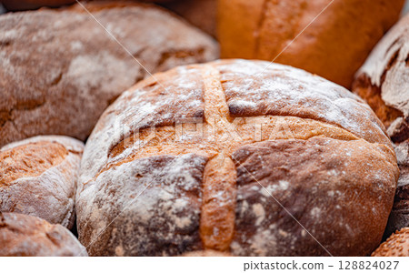 Freshly baked natural bread is on the kitchen table. Freshly baked natural bread is on the kitchen table. 128824027