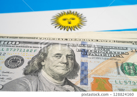 US dollar banknotes on Argentina flag background, Business and finance. 128824160