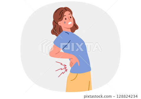 Woman suffers from pain in spine and needs massage or warming ointment to combat radiculitis 128824234