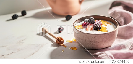 Rustic clay cup filled with creamy kefir and garnished with honey and fresh berries in soft light Rustic clay cup filled with creamy kefir and garnished with honey and fresh berries in soft light 128824402