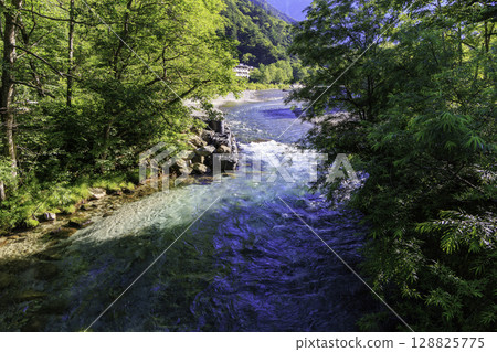 A clear, transparent stream and the beautiful blue color of the Azusa River in summer A clear, transparent stream and the beautiful blue color of the Azusa River in summer 128825775