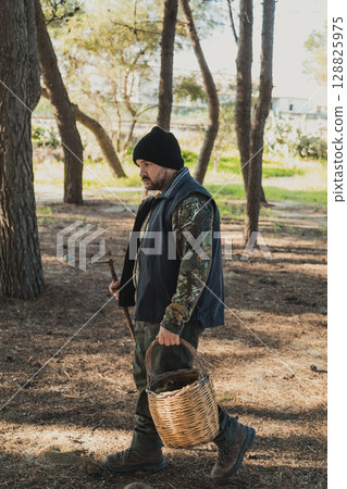 Man In The Nature Looking For Porcini Mushrooms  128825975