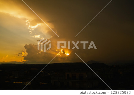 Twilight landscape with vibrant clouds and hills 128825983