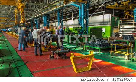 Conveyor assembly stage the body of tractor at big industrial factory timelapse 128826004