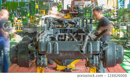 Conveyor assembly stage the body of tractor at big industrial factory timelapse Conveyor assembly stage the body of tractor at big industrial factory timelapse 128826008