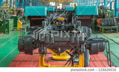 Conveyor assembly stage the body of tractor at big industrial factory timelapse Conveyor assembly stage the body of tractor at big industrial factory timelapse 128826016
