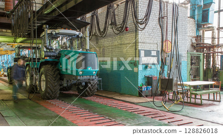 Conveyor assembly stage the body of tractor at big industrial factory timelapse 128826018