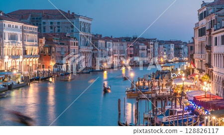 Grand Canal in Venice, Italy day to night timelapse. Gondolas and city lights from Rialto Bridge. Grand Canal in Venice, Italy day to night timelapse. Gondolas and city lights from Rialto Bridge. 128826117