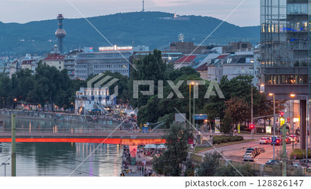 Aerial view along the Danube Canal in Vienna day to night timelapse after sunset 128826147