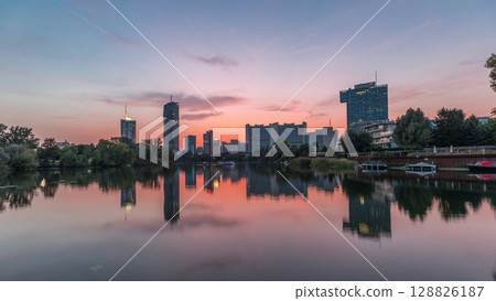 Vienna international center skyscrapers with Kaiserwasser lake reflection view day to night timelapse Vienna international center skyscrapers with Kaiserwasser lake reflection view day to night timelapse 128826187