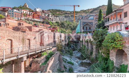 Abanotubani district in Old Tbilisi, Georgia where most of the Sulphur baths are located aerial timelapse. 128826223