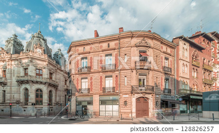 Panorama showing historic brick facades at Rue du Languedoc and Theodore Ozenne intersection timelapse in Toulouse, France. 128826257