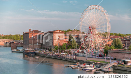 Aerial view of a Ferris wheel at Viguerie Port on the Garonne River timelapse, Toulouse, France Aerial view of a Ferris wheel at Viguerie Port on the Garonne River timelapse, Toulouse, France 128826262