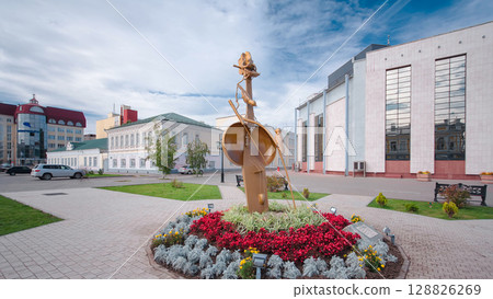 Sculpture with flowers and the building of Kazakh Drama Theatre in Uralsk timelapse hyperlapse. Sculpture with flowers and the building of Kazakh Drama Theatre in Uralsk timelapse hyperlapse. 128826269