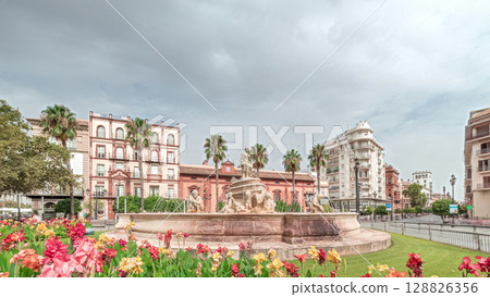 Hispalis Fountain in Seville surrounded by flowers and historical buildings timelapse Hispalis Fountain in Seville surrounded by flowers and historical buildings timelapse 128826356