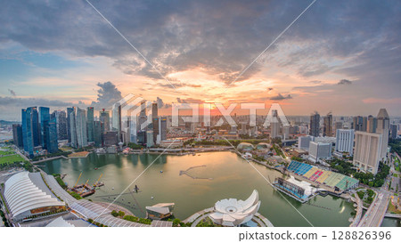 Panorama of Singapore Marina Bay with Financial District skyscrapers at sunset light reflected on the harbor timelapse. Panorama of Singapore Marina Bay with Financial District skyscrapers at sunset light reflected on the harbor timelapse. 128826396