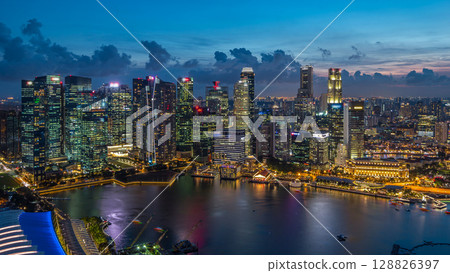 Aerial view of Singapore business district skyscrapers at evening with water reflections day to night timelapse 128826397