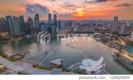 Panorama of Singapore Marina Bay with Financial District skyscrapers at sunset light reflected on the harbor timelapse. 128826404