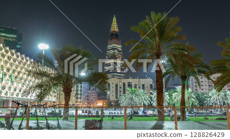 Perspective night timelapse of the King Fahad National Library's illuminated facade with palms and glowing tower in view. Riyadh, Saudi Arabia. Perspective night timelapse of the King Fahad National Library's illuminated facade with palms and glowing tower in view. Riyadh, Saudi Arabia. 128826429