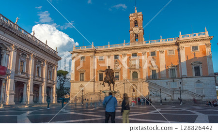 Capitoline hill landmark square timelapse hyperlapse surrounded by neo classic museums buildings with clock tower and bronze statue of Mark Aurelius 128826442