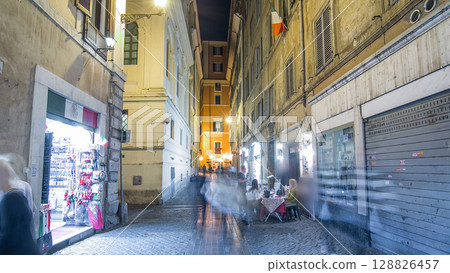 Walk down streets of Rome timelapse hyperlapse from the Pantheon to fountain Trevi showing restaurants and the blur of people at night 128826457