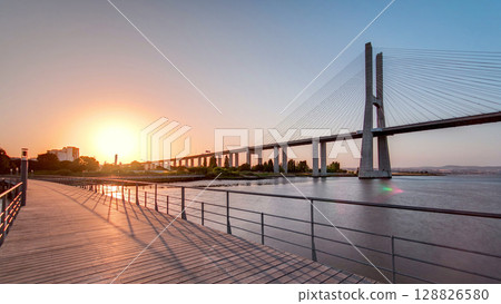 Vasco da Gama bridge during sunset and ebb-tide in Lisbon, Portugal. Timelapse Vasco da Gama bridge during sunset and ebb-tide in Lisbon, Portugal. Timelapse 128826580