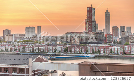 Aerial timelapse of modern buildings in Rotterdam city center during sunset, The Netherlands. 128826637