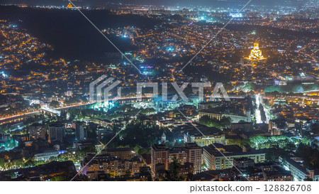 Illuminated Tsminda Sameba Cathedral or Holy Trinity Cathedral of Tbilisi and Public Service Hall aerial night timelapse Georgia Illuminated Tsminda Sameba Cathedral or Holy Trinity Cathedral of Tbilisi and Public Service Hall aerial night timelapse Georgia 128826708